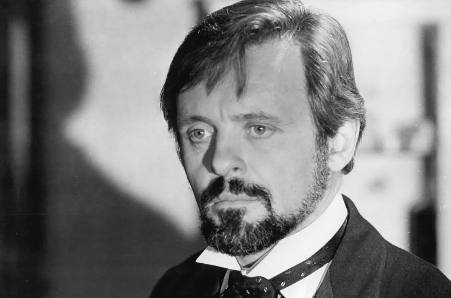 Brooks Films Black and white photo of Sir Anthony as Dr Treves looking unsmilingly to camera with moustache and beard, white collar and cravat