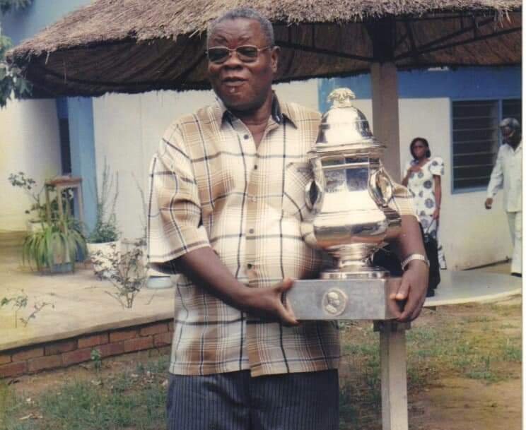 The late Dr Victor Attoh takes a moment with the CAF Super Cup Trophy won by Hearts of Oak in the 2000s