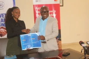 Ghana TVET Service Mr Eric K. Adzroe right and Ms Constance Swaniker exchanging the signed document
