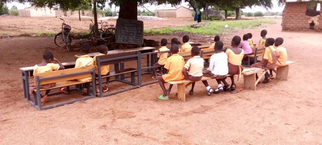 Dilapidated classroom block inset Pupils studying under the tree