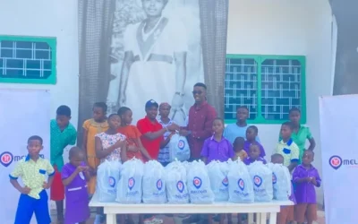 Melcom Care Foundation donates meals Mr Kpormegbey right back row presenting the packed meals to the