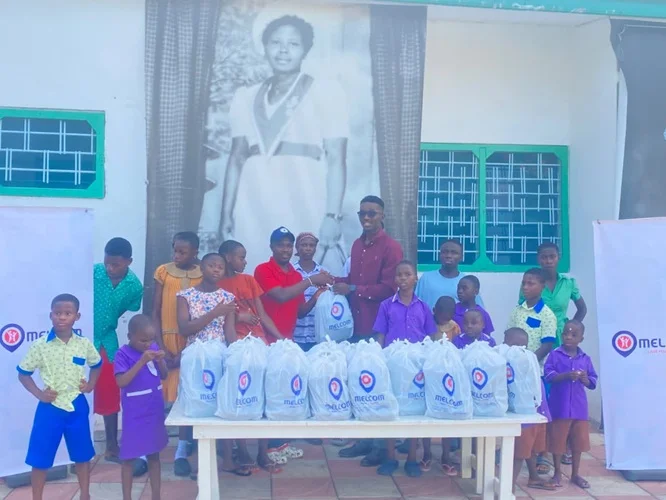 Melcom Care Foundation donates meals Mr Kpormegbey right back row presenting the packed meals to the