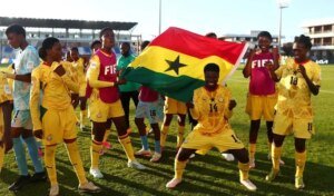 Players and officials of the Black Maidens celebrating their qualification