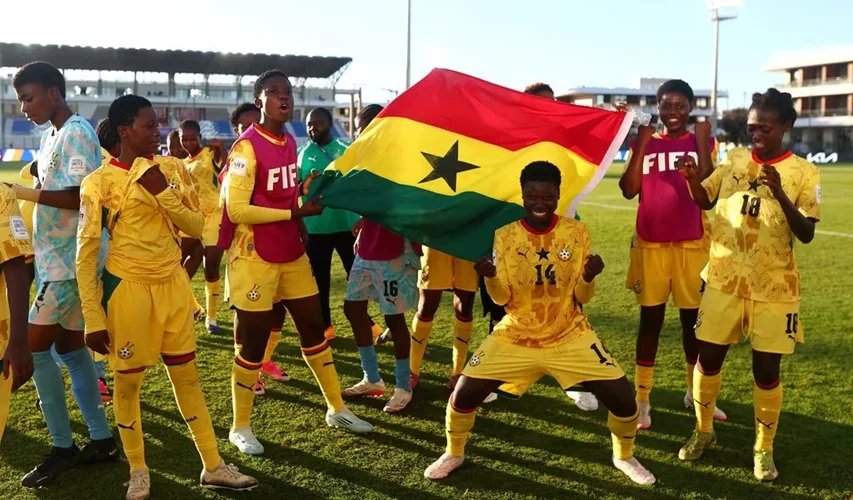 Players and officials of the Black Maidens celebrating their qualification